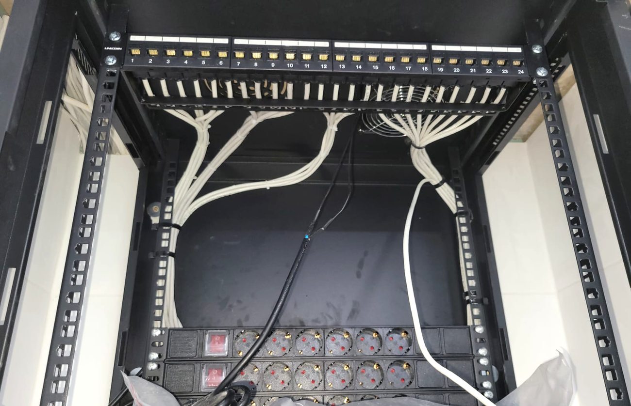 Open rack showing a 24-port patch panel punched down and dressed above two rack-mounted power distribution strips